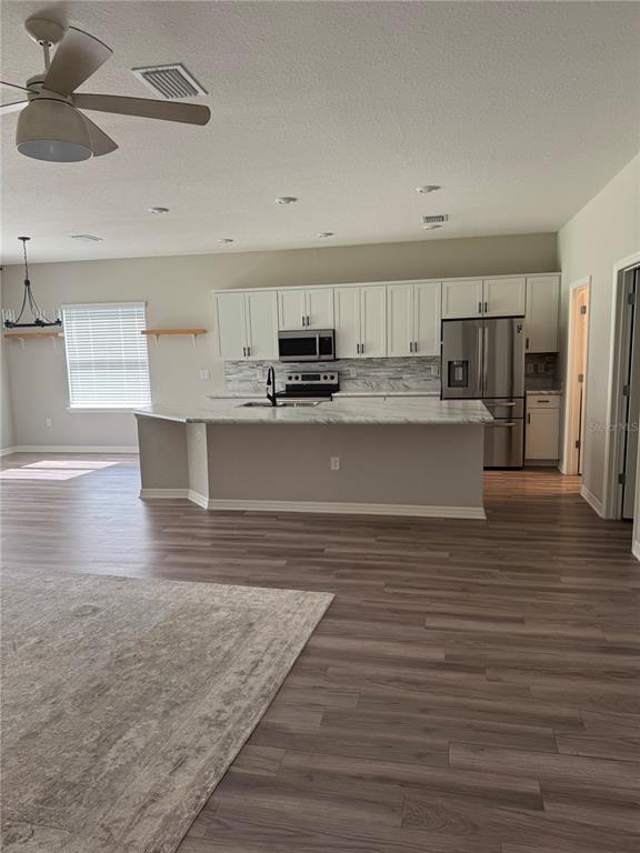 5515 Southeast 91st Street Ocala, FL 34480 - Photo 24 of 40 a view of kitchen with stainless steel appliances cabinets and wooden floor