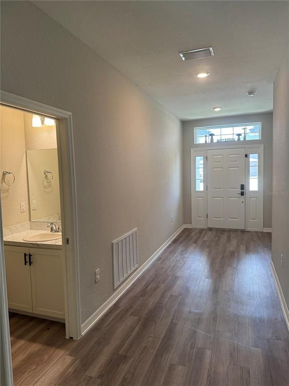 5515 Southeast 91st Street Ocala, FL 34480 - Photo 35 of 40 an empty room with wooden floor and windows