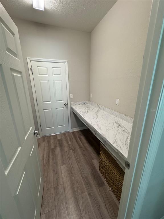 5515 Southeast 91st Street Ocala, FL 34480 - Photo 37 of 40 a view of an empty room with wooden floor and vanity