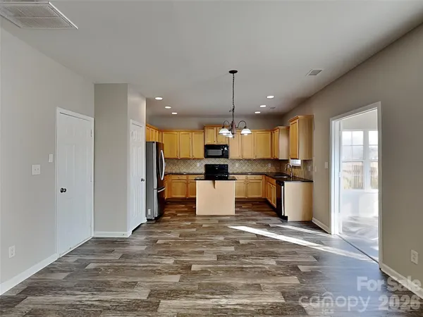 a large kitchen with a large counter top appliances and cabinets