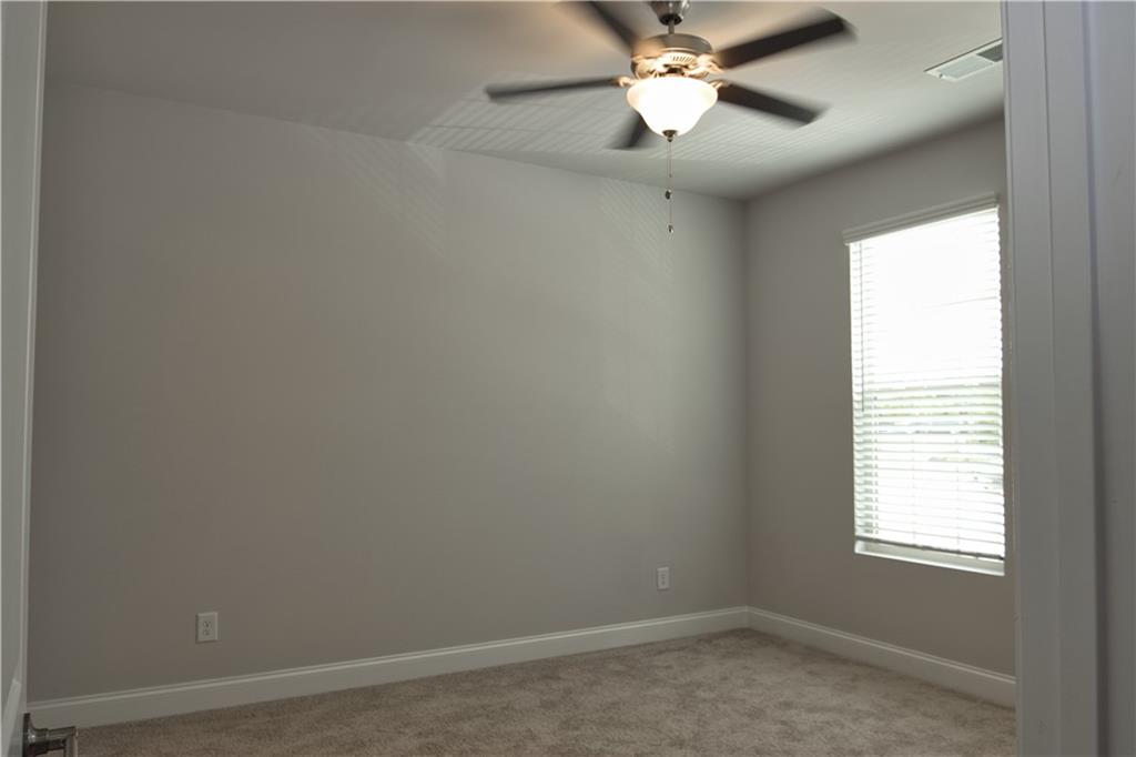6120 Ripple Way, Unit 46 Atlanta, GA 30349 - Photo 11 of 19 an empty room with a window and a fan