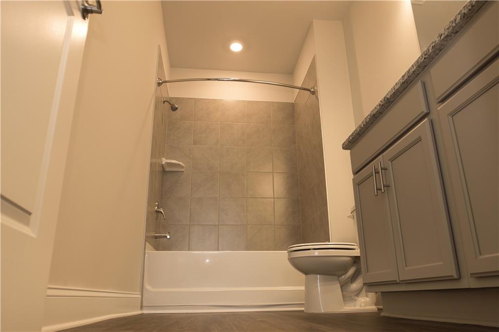 6120 Ripple Way, Unit 46 Atlanta, GA 30349 - Photo 16 of 19 a bathroom with a bathtub and a shower