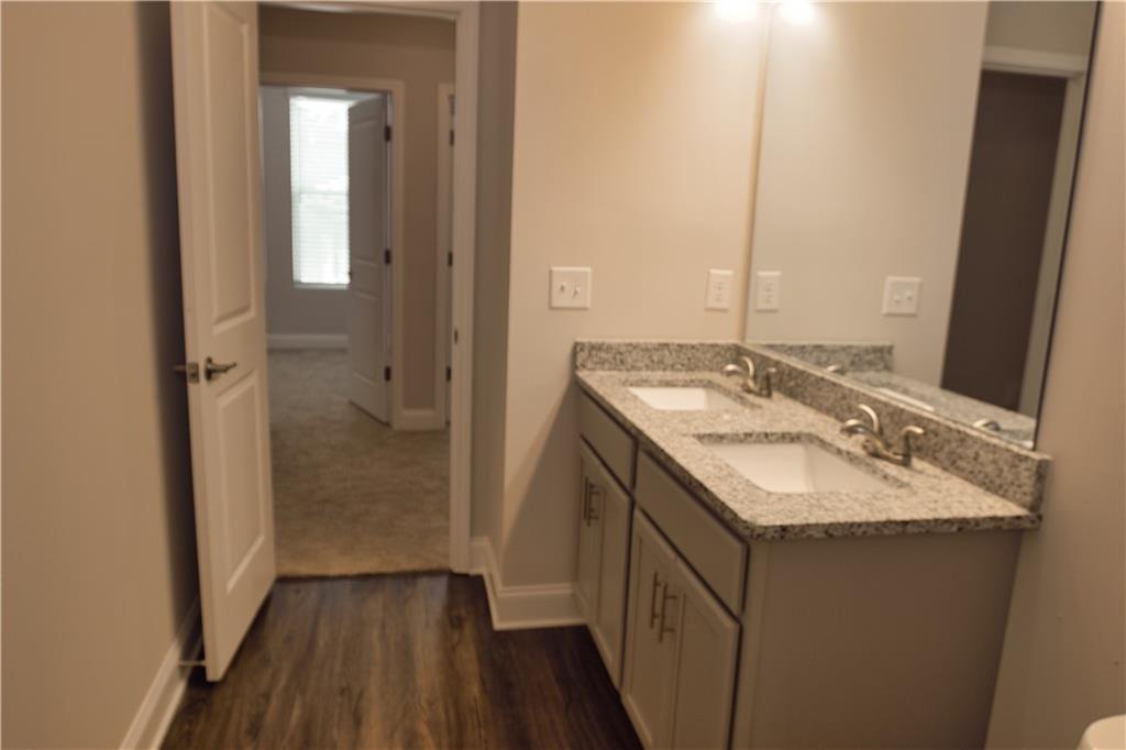 6120 Ripple Way, Unit 46 Atlanta, GA 30349 - Photo 17 of 19 a bathroom with a sink and a mirror