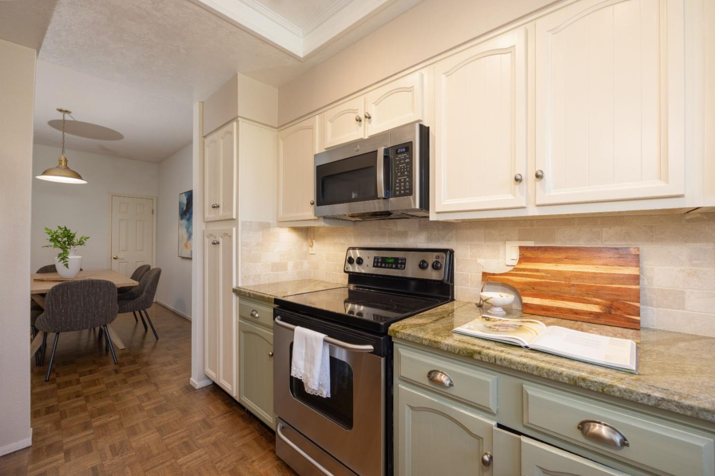 21 Pinehurst Lane Half Moon Bay, CA 94019 - Photo 12 of 43 a kitchen with stainless steel appliances a stove a microwave and cabinets