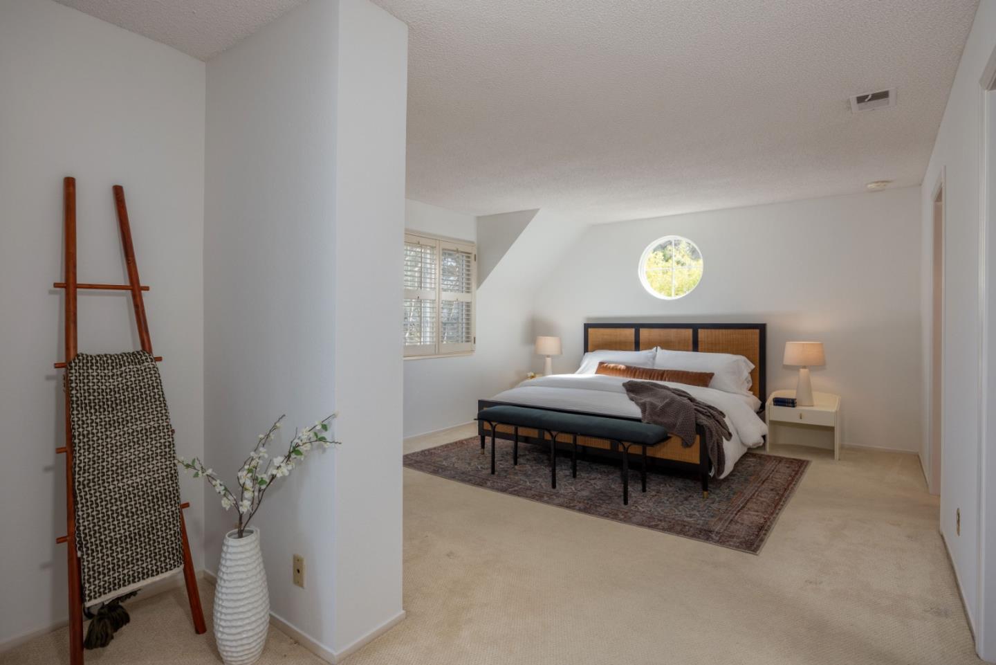 21 Pinehurst Lane Half Moon Bay, CA 94019 - Photo 20 of 43 a bedroom with a bed and a chandelier