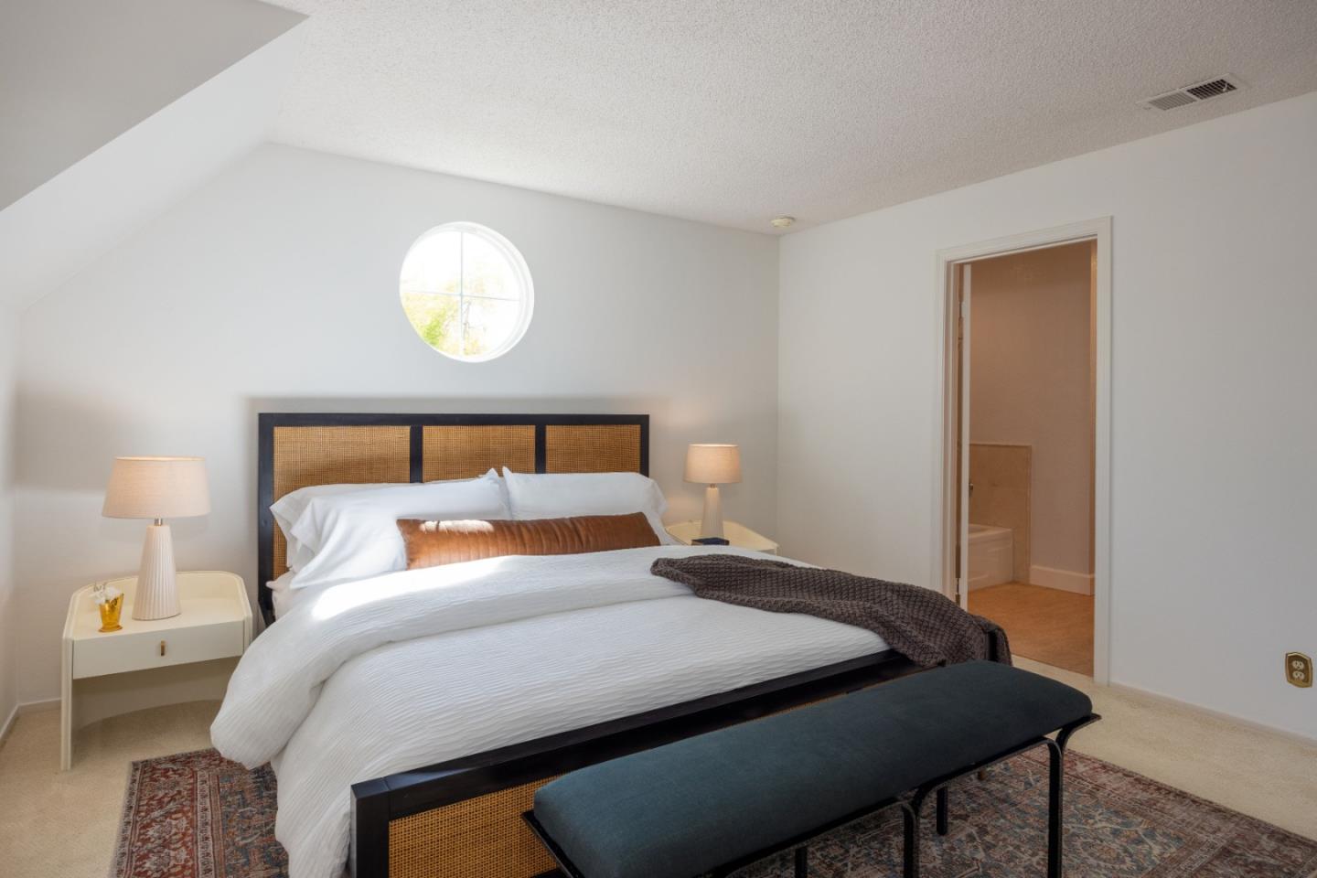 21 Pinehurst Lane Half Moon Bay, CA 94019 - Photo 22 of 43 a bedroom with a bed and a lamp