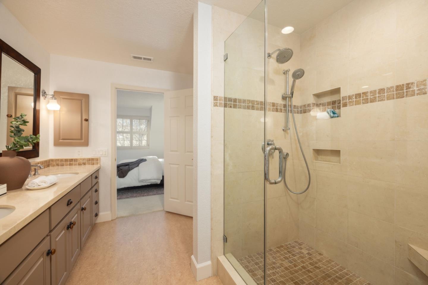 21 Pinehurst Lane Half Moon Bay, CA 94019 - Photo 26 of 43 a en suite bathroom with a shower sink and mirror