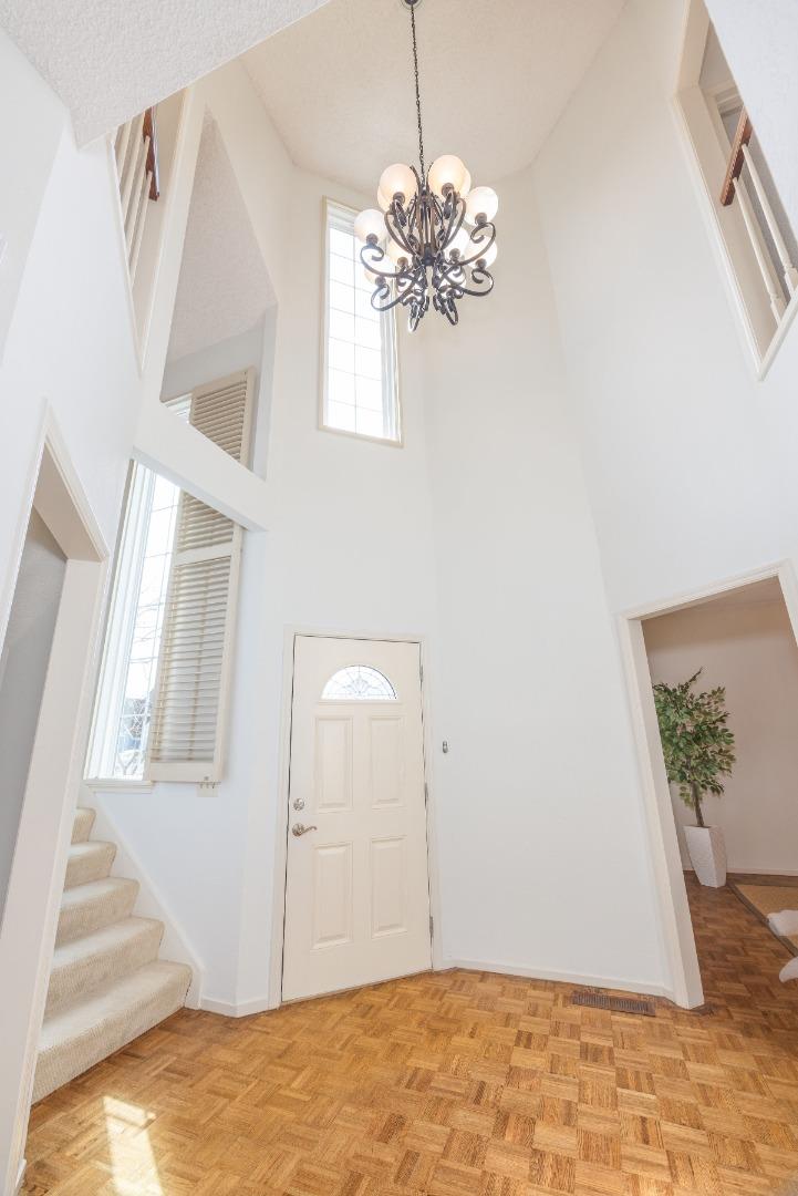 21 Pinehurst Lane Half Moon Bay, CA 94019 - Photo 3 of 43 a view of a bedroom with wooden floor and chandelier