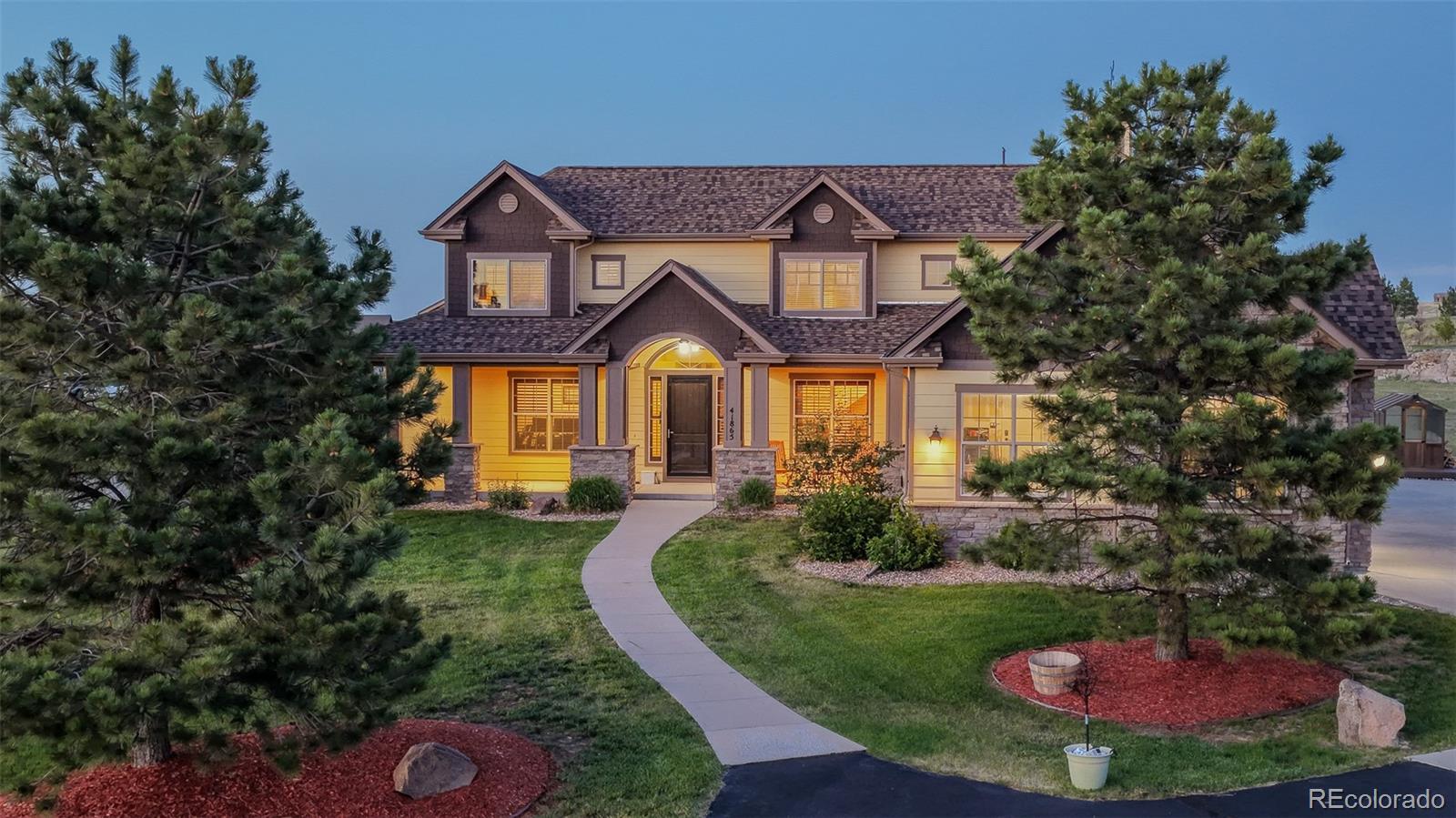 41865 East Muirfield Loop Elizabeth, CO 80107 - Photo 3 of 50 a front view of a house with a yard
