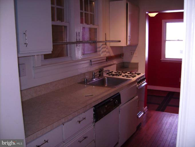 1700 Ednor Road Silver Spring, MD 20905 - Photo 3 of 18 a kitchen with stainless steel appliances a cabinets and wooden floor