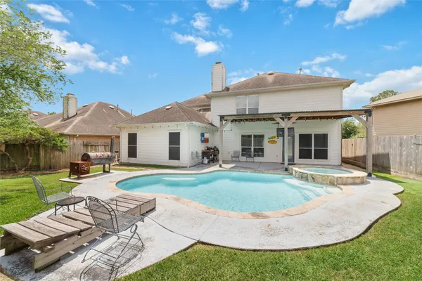 a view of a house with backyard and sitting area