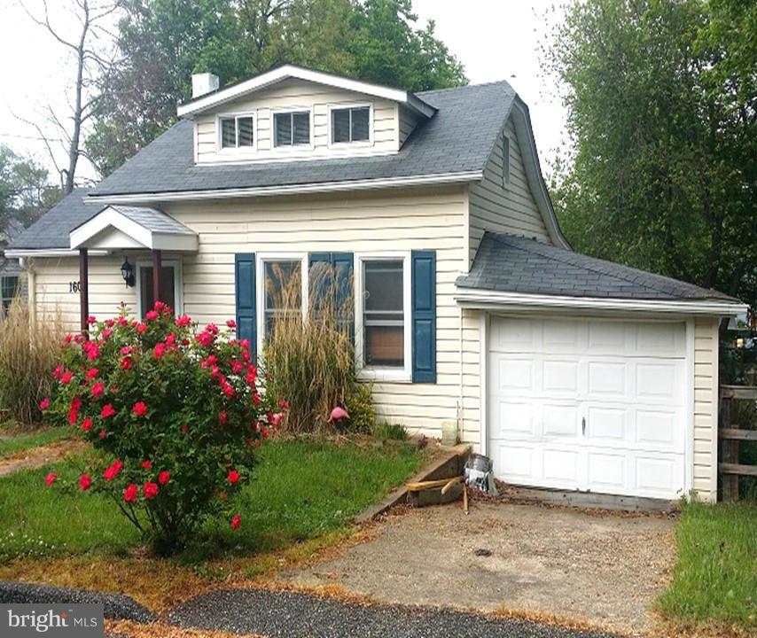 1607 Oldtown Road Edgewater, MD 21037 - Photo 1 of 11 a front view of a house with a garden