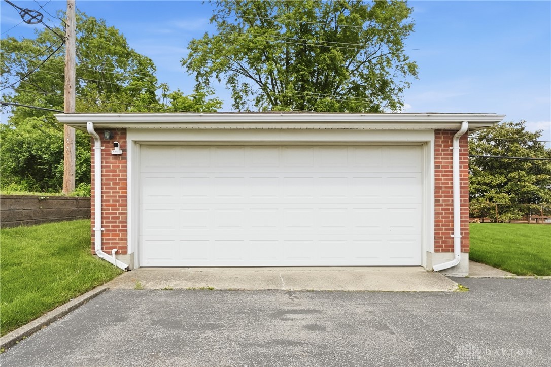 877 Woodhill Road Riverside, OH 45431 - Photo 37 of 42 This convenient garage with a paved driveway offers practical and secure parking.