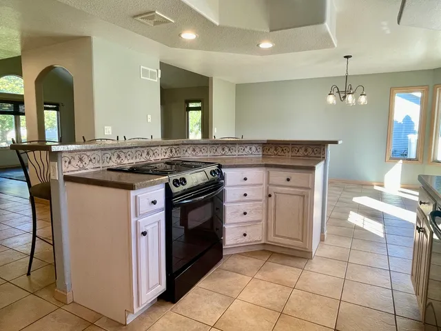 a kitchen with a stove and a refrigerator