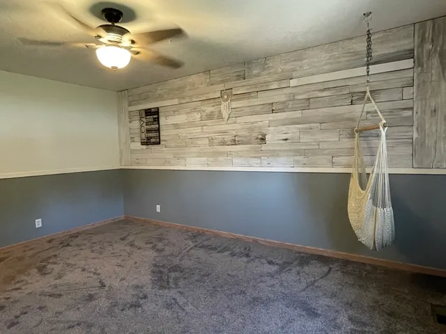 a very nice looking room with a ceiling fan and a window