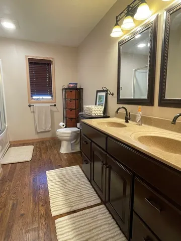 a bathroom with a double vanity sink and a mirror