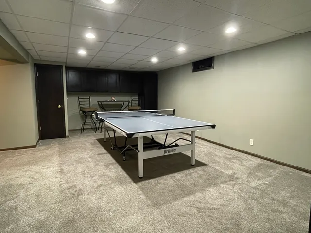 a room with pool table and a projector