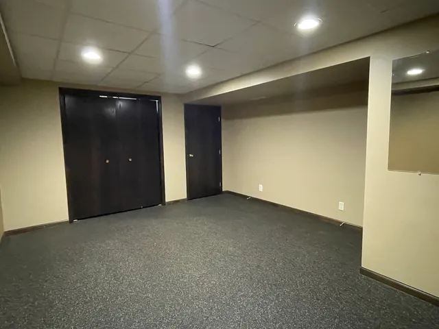 a backyard of a house with garden and plants