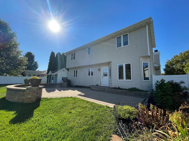 a view of a patio with table and chairs and potted plants
