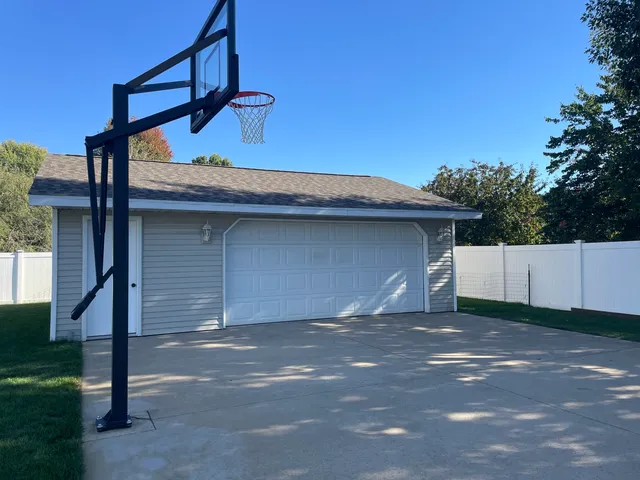 a view of a large pool with lawn chairs and a big yard