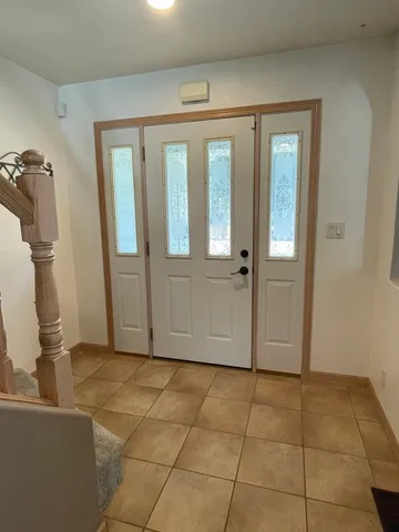 a view of a livingroom with wooden floor and a cabinet