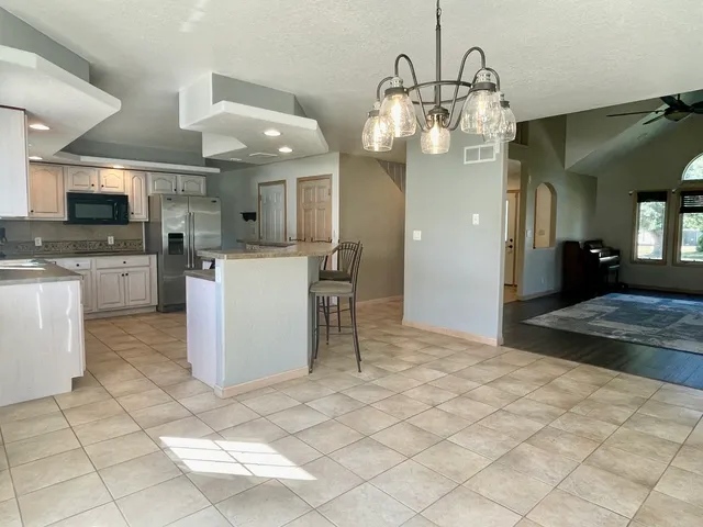 a kitchen with a cabinets and chandelier