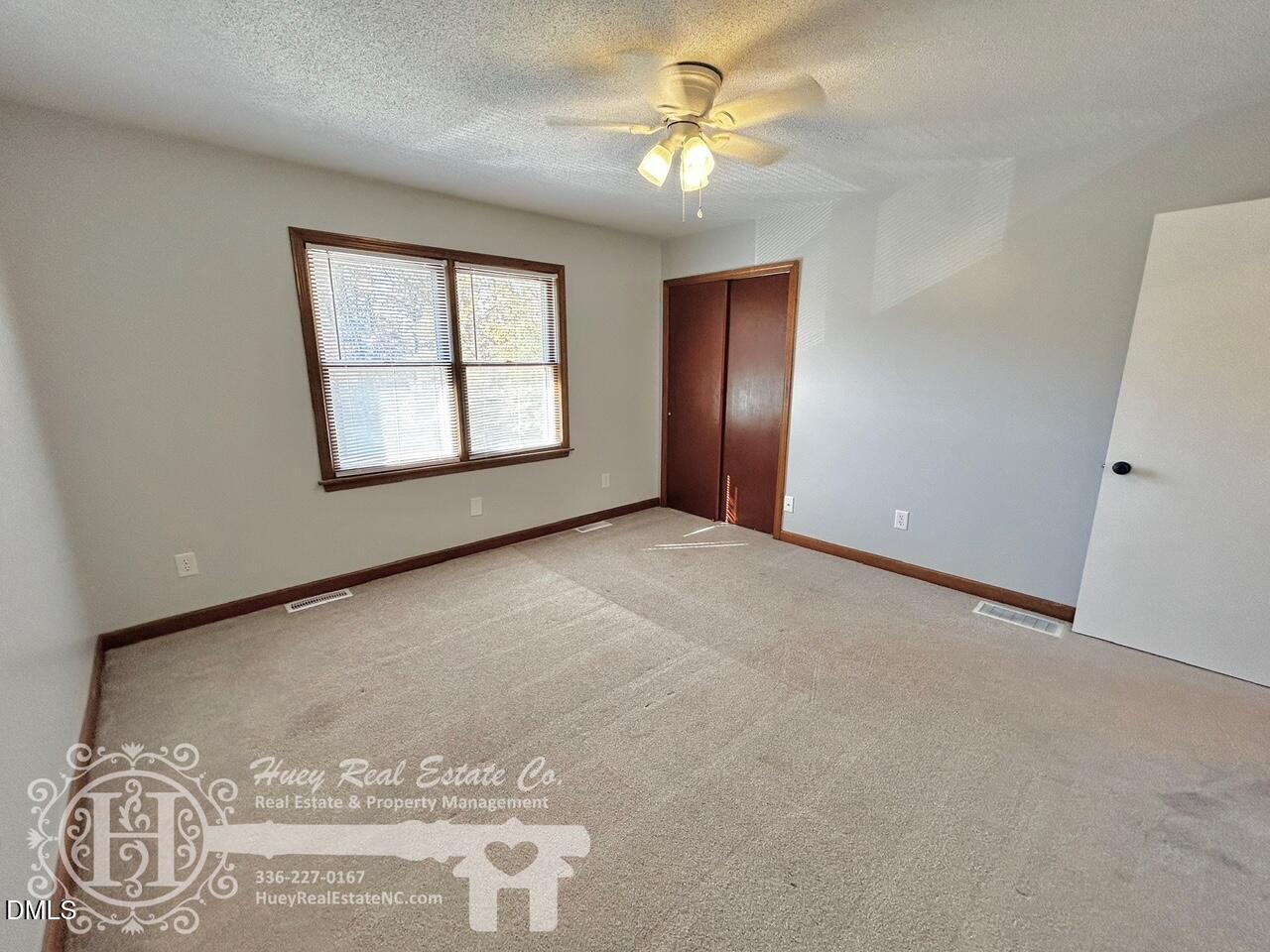 296 Seventh Avenue, Unit 3 Yanceyville, NC 27379 - Photo 17 of 21 an empty room with windows and closet