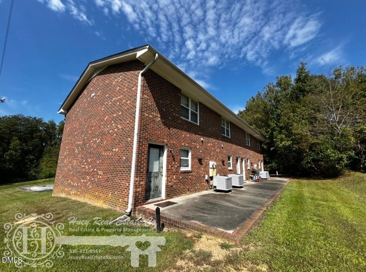 296 Seventh Avenue, Unit 3 Yanceyville, NC 27379 - Photo 2 of 21 a view of a house with a yard