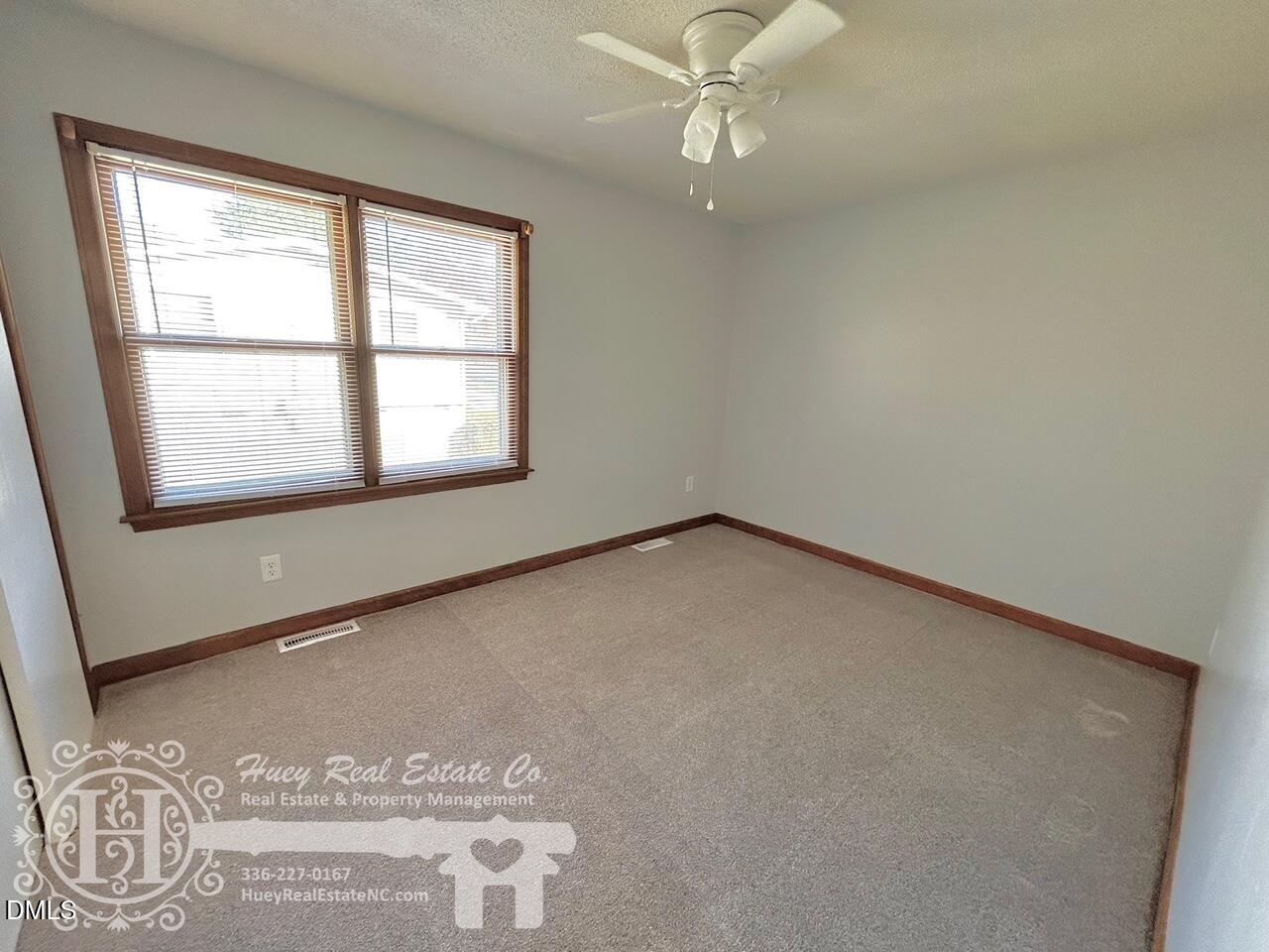 296 Seventh Avenue, Unit 3 Yanceyville, NC 27379 - Photo 21 of 21 an empty room with a window