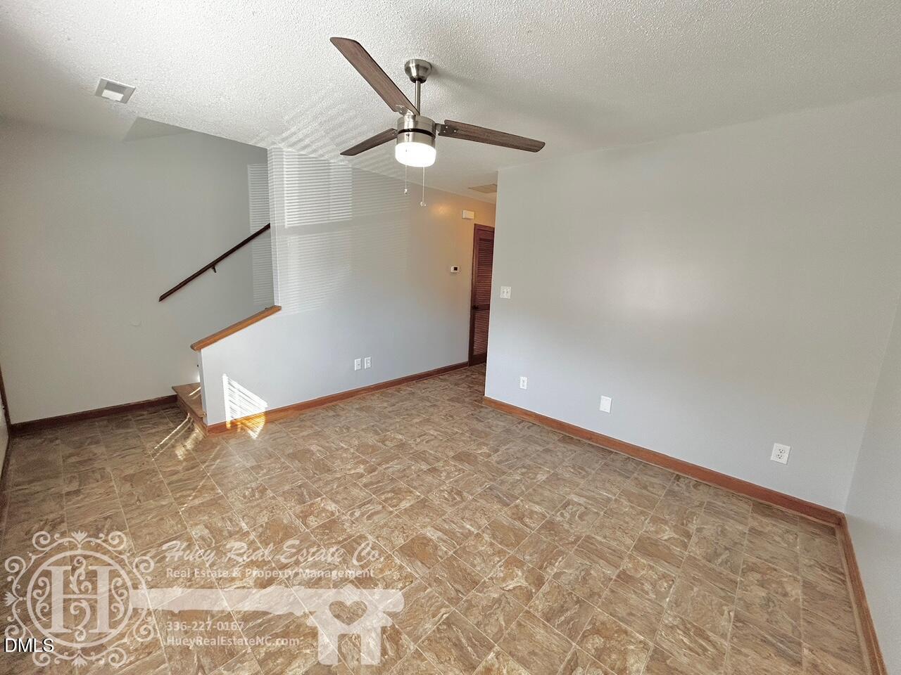 296 Seventh Avenue, Unit 3 Yanceyville, NC 27379 - Photo 5 of 21 an empty room with a ceiling fan and window
