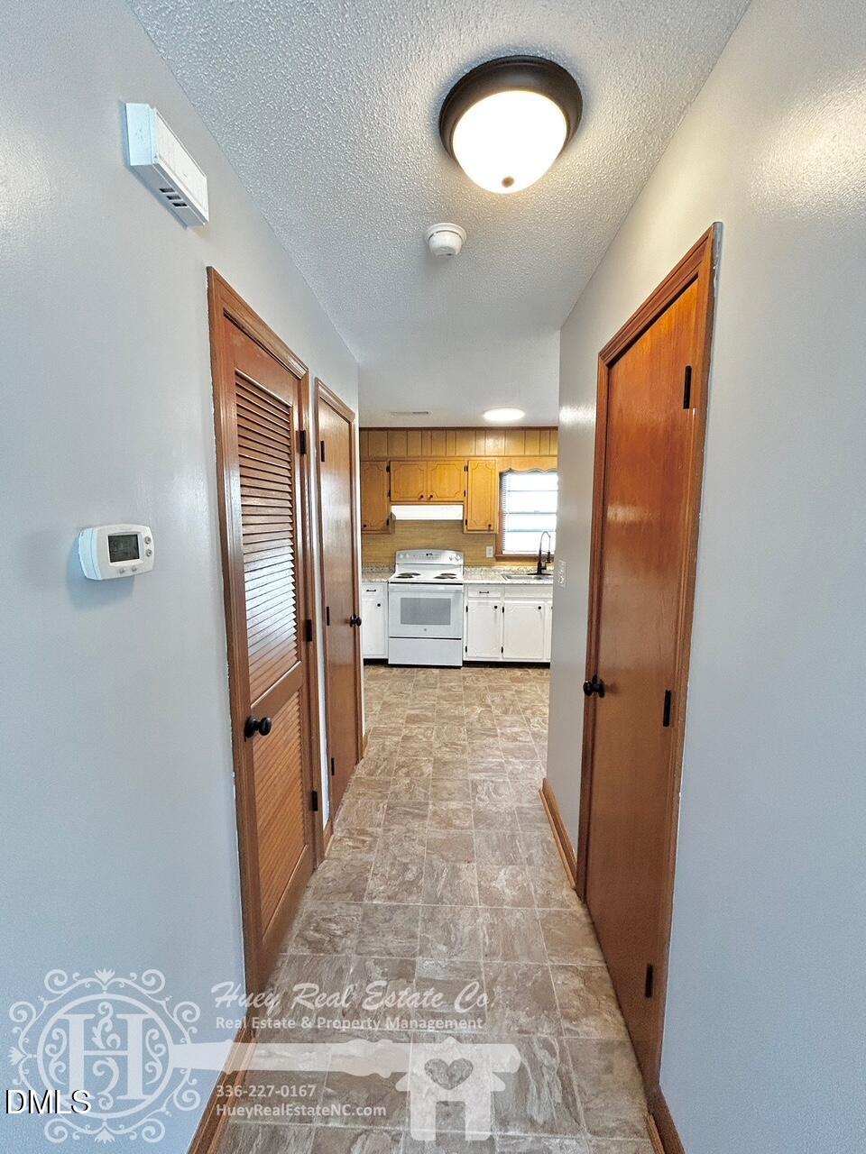 296 Seventh Avenue, Unit 3 Yanceyville, NC 27379 - Photo 7 of 21 a view of a hallway with wooden floor and a bathroom