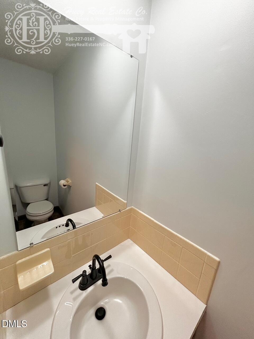 296 Seventh Avenue, Unit 3 Yanceyville, NC 27379 - Photo 8 of 21 a bathroom with a sink and a mirror