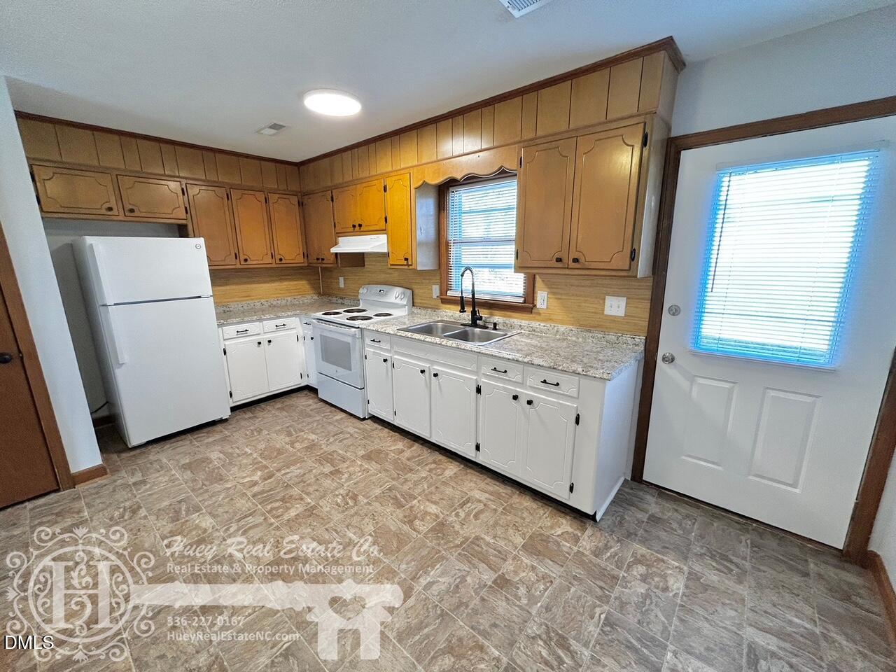 296 Seventh Avenue, Unit 3 Yanceyville, NC 27379 - Photo 10 of 21 a kitchen with a sink stove and refrigerator