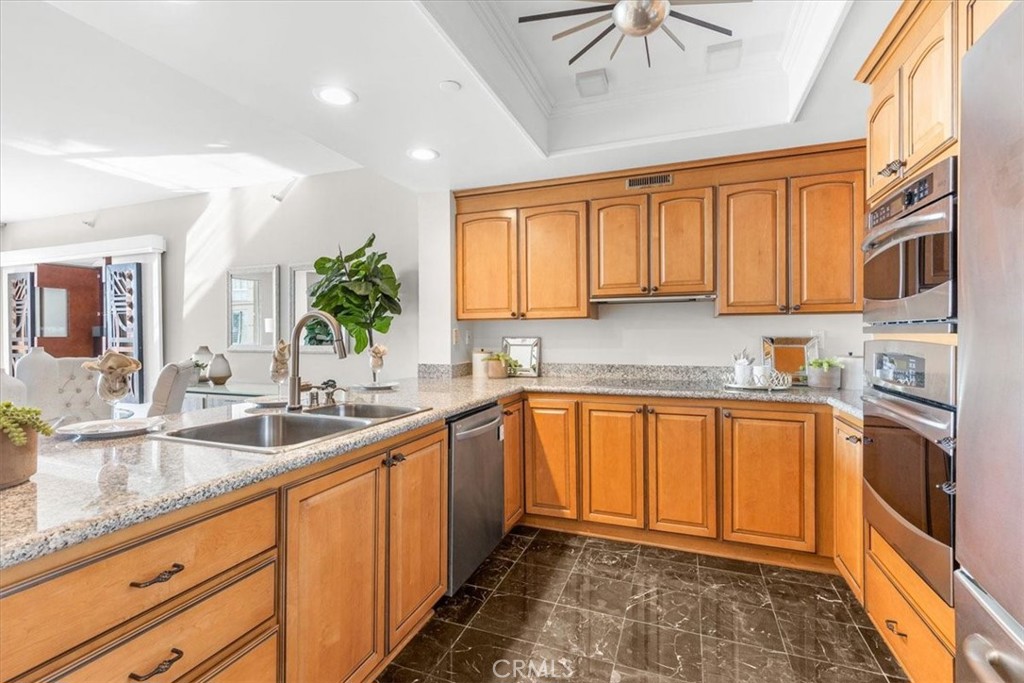 850 East Ocean Boulevard, Unit 209 Long Beach, CA 90802 - Photo 2 of 15 a kitchen with stainless steel appliances granite countertop a sink stove and cabinets