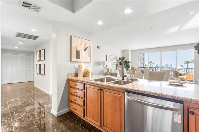 a kitchen with stainless steel appliances granite countertop a sink and cabinets