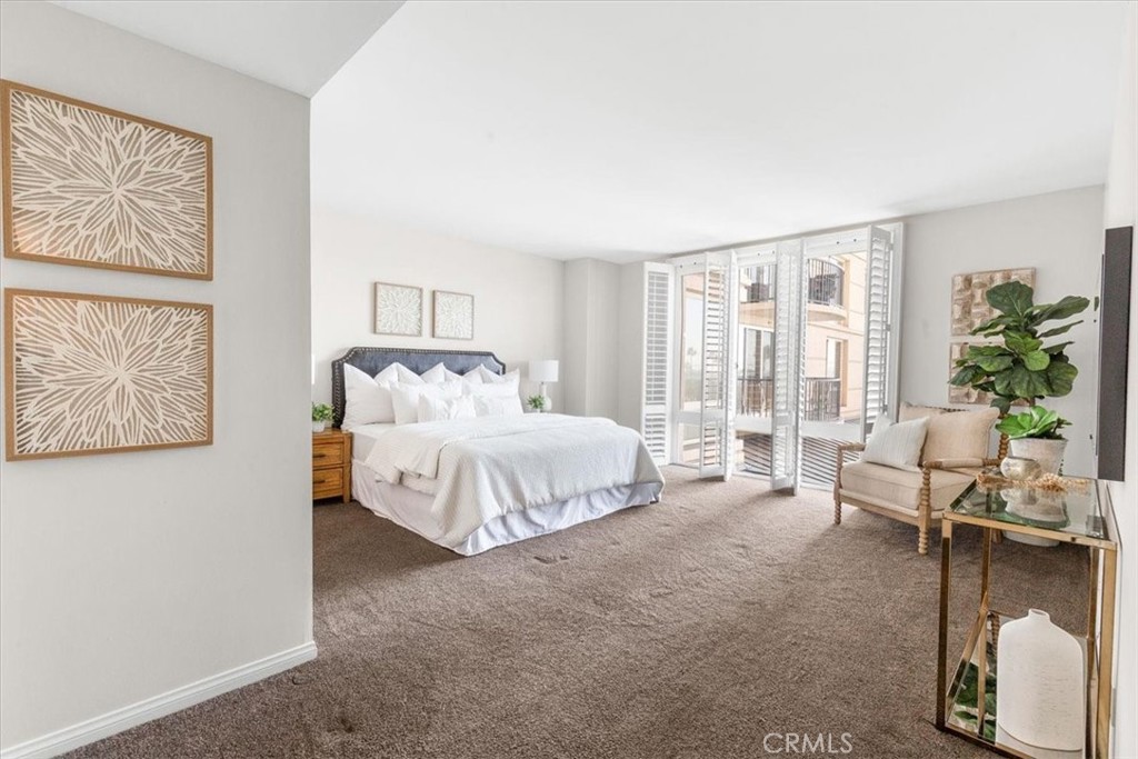 850 East Ocean Boulevard, Unit 209 Long Beach, CA 90802 - Photo 7 of 15 a spacious bedroom with a bed and a couch