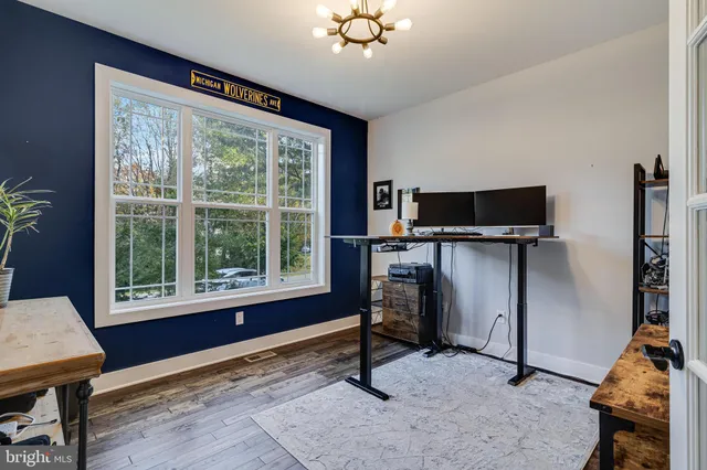 a view of a workspace with furniture and a window