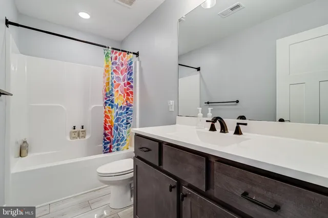 a bathroom with a sink a toilet and a bathtub