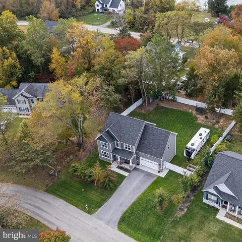 an aerial view of a house with garden space and street view