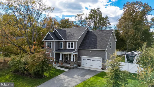a view of house with garden space and sitting area