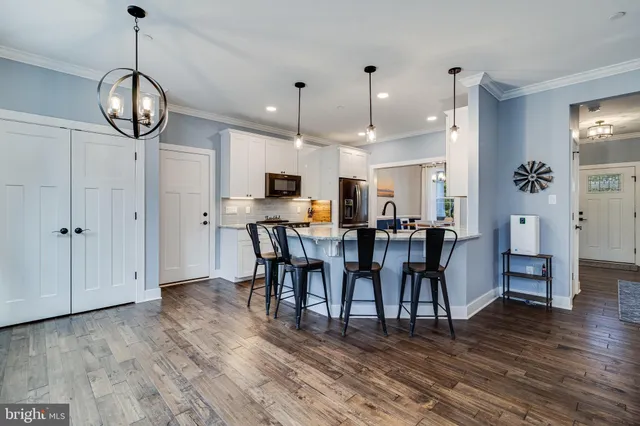 a view of a dining room with furniture and wooden floor