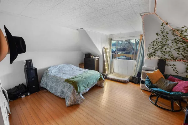 a bed sitting in a room next to a window