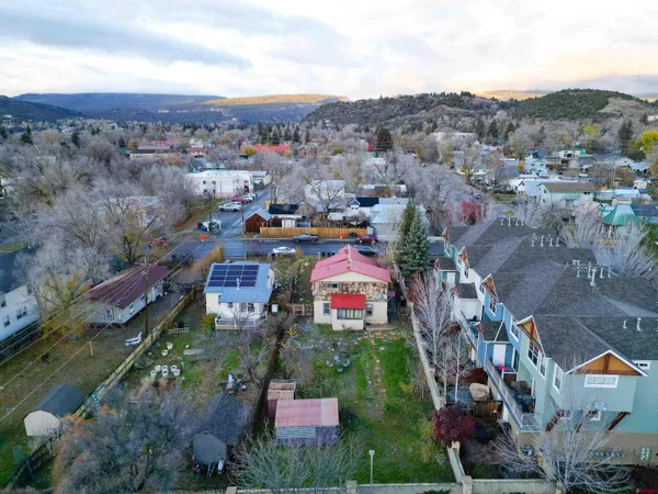 an aerial view of a house with a yard