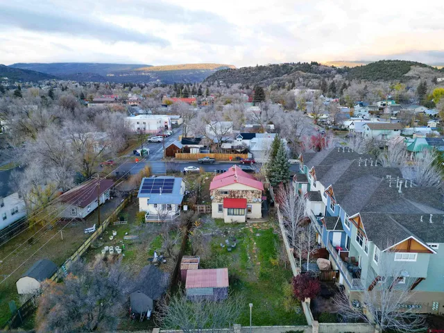 an aerial view of a house with a yard