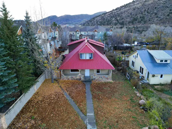 an aerial view of a house with a yard