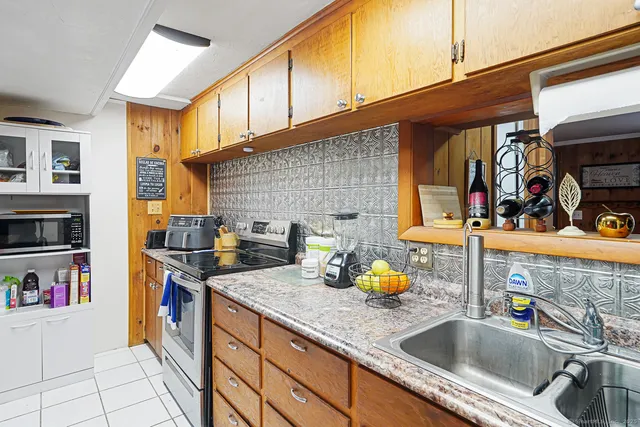 a kitchen with stainless steel appliances granite countertop a sink and a wooden cabinets