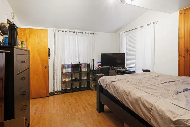 a bedroom with a bed and a flat screen tv
