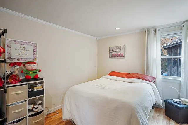 a bedroom with a bed and a window