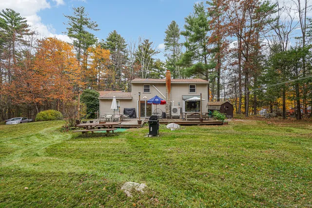 a view of a house with backyard and sitting area