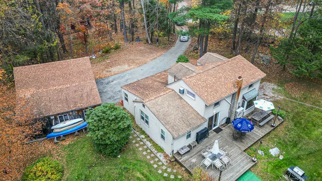 an aerial view of a house with swimming pool and lake view